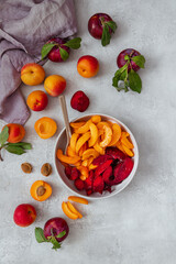 Sliced plums and apricots in a bowl