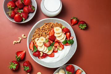 Granola with yogurt, strawberry and banana in a bowl