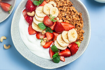 Granola with yogurt, strawberry and banana in a bowl
