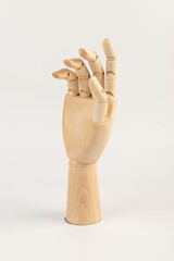 Wooden hand isolated on a white background. Copy space