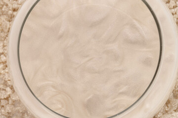 Shimmering bath salt. Beige sea salt in colored water