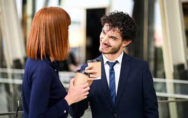 Business partners discussing together outdoor in a modern urban setting during a coffee break