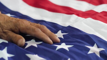 old man's hand on the american flag, veteran of american special services, patriotism and sense of duty, emotions of old people, independence day of america - Powered by Adobe