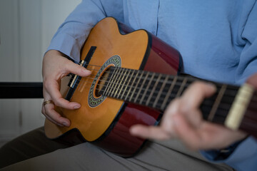 Fototapeta na wymiar Woman plays guitar
