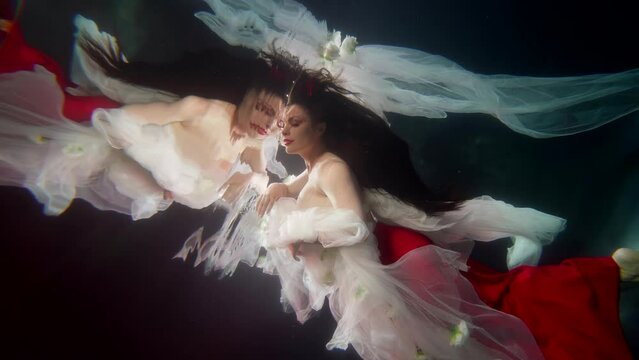 enigmatic lady and her reflection underwater, pretty brunette swimming in magical depth of sea