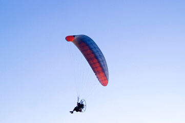 Paramotor in silhouette, flying over region of Campinas - SP, Brazil,