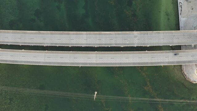 Birds eye view of Florida Keys Overseas Highway 1 with cars and traffic in South Florida during golden hour sunset - 4K Drone