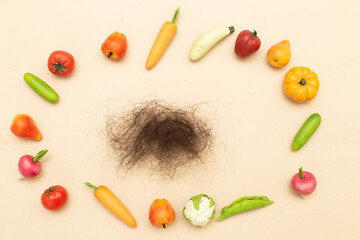 lost hair on a beige background with a different healthy food products
