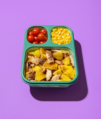 Lunch box with summer salad on a purple background. Prep meal lunch box.