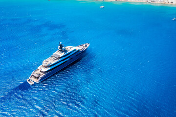 A drone view of a luxury yacht in the middle of the sea. Vacation and holidays. Summer time for sea travel. The sea bay. Photo for background and wallpaper. Mediterranean Sea.
