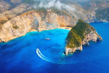 View of Navagio beach, Zakynthos Island, Greece. Aerial landscape. Azure sea water. Top view from a drone. Summer time for sea travel. The sea bay. Photo for background and wallpaper.