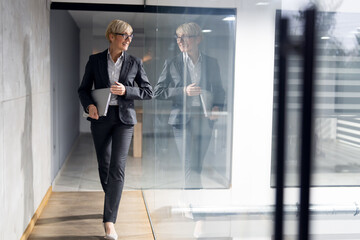 Middle aged business woman walking at business center