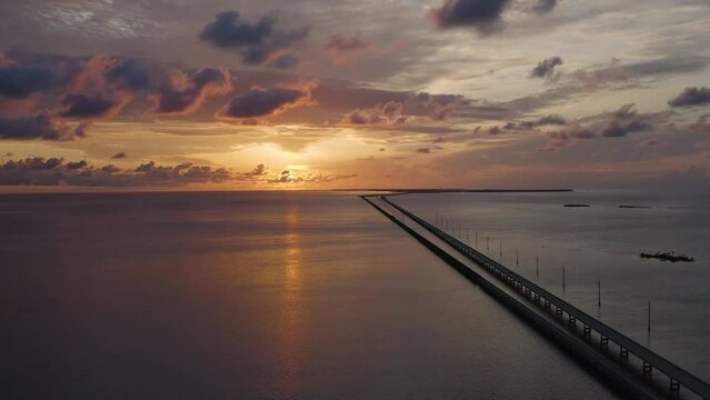 Aerial view of morning sunrise in Florida Keys landscape with Seven Mile Bridge and Overseas Highway traffic - 4K Drone