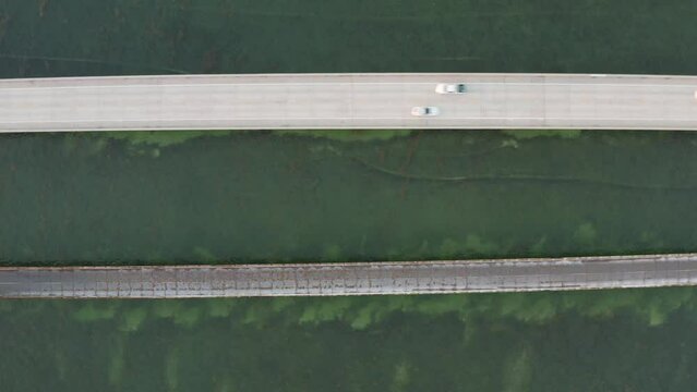 Birds eye view of Seven Mile Bridge with cars and traffic over Money Key Channel in the Florida Keys - 4K Drone