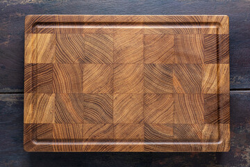 Empty wooden cutting board, top view with copy space for text or design elements.