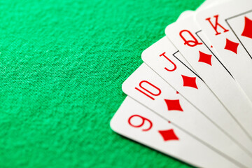 Poker combination straight flush five cards of suit of diamonds from nine to king, selective focus .