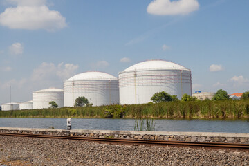 Fuel oil tank with white color and blue sky. The photo is suitable to use for industry background and content media.