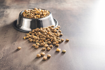Dry kibble pet food. Dog or cat food on old table.