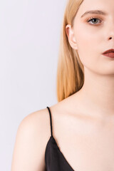 Naklejka premium Close-up portrait of a young and elegant girl on a white background.