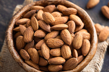 Raw almonds in a bowl, closeup view. Healthy food
