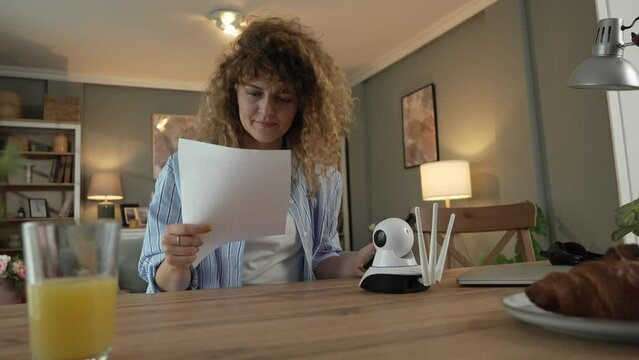 One woman adjust home surveillance security camera scan code
