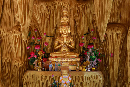 Si Mueang Mai District Ubon Ratchathani Province, Thailand - 5 March 2023: Phra Sethi Nawakoti meditating inside the golden cave at Wat Pa Phu Pang