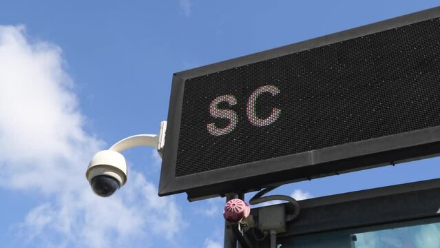 Safety car motorsport electronic panel flag signal, racetrack equipment, flashing against blue sky