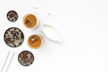 Two glasses of cold drew coffee drink with ice with coffee beans