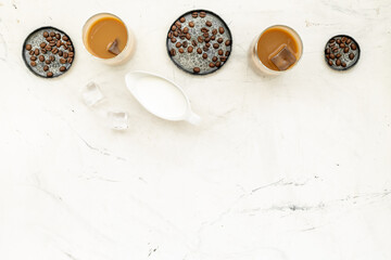 Top view of cold latte coffee with ice and coffee beans