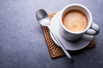 Espresso cup on gray background, close-up, space for text.