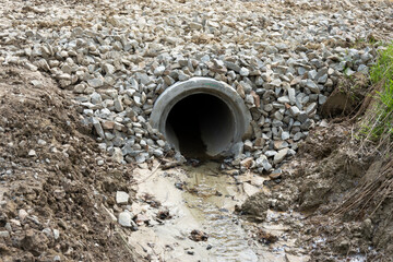 A drainage pipe in nature for the flow of a small stream under a forest road