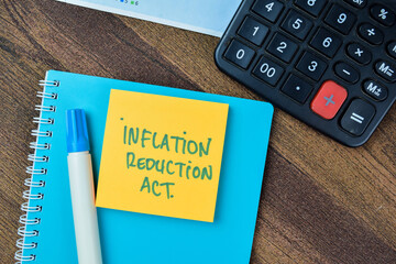 Concept of Inflation Reduction Act write on sticky notes isolated on Wooden Table.