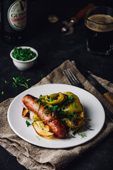 Oven baked pork sausage with bell peppers, onions and different herbs