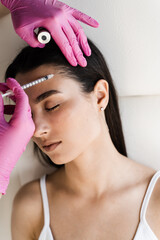 Cosmetologist is making mesotherapy injections in hair of girl. Mesotherapy treatment nourish the...