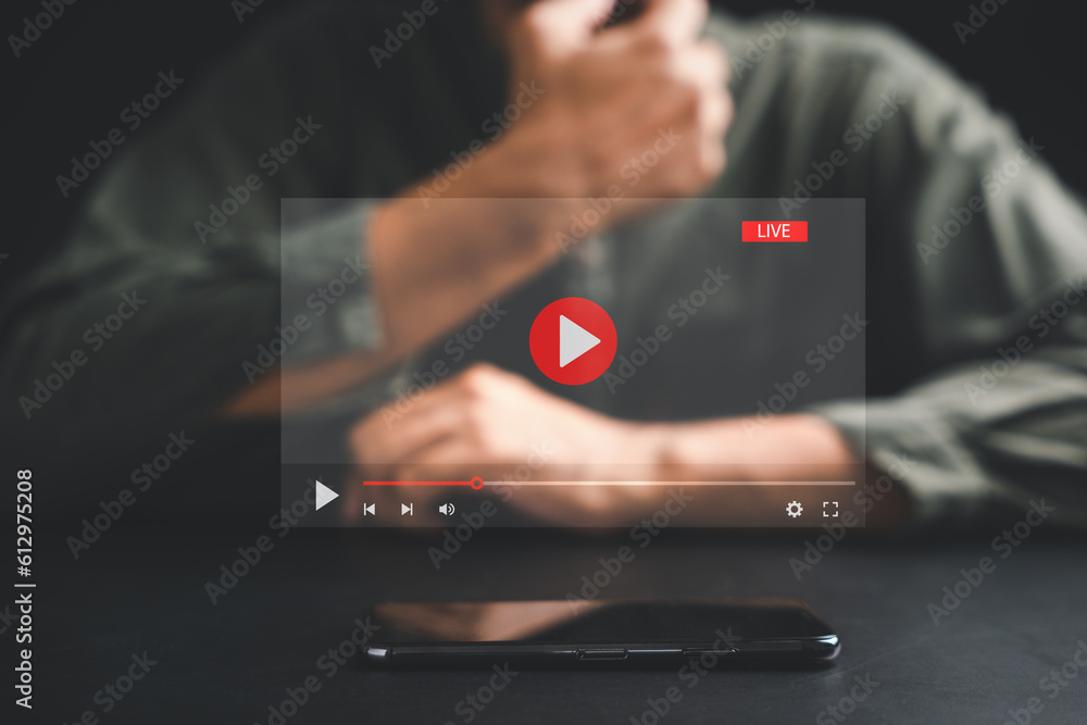 Poster man initiates live streaming on a smartphone, captivated by the video streaming and multimedia displ