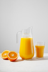 Naklejka na ściany i meble Orange juice in a glass transparent decanter