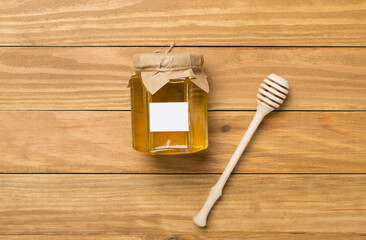 Jar with different honey on wooden background, top view. Mock up design