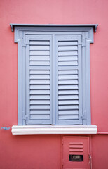 Antique window with a gray shutter in Plaka, Greece.