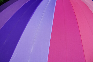 Obraz na płótnie Canvas background of umbrellas. Rainbow umbrella for pride month, freedom and protection concept for LGBTQ+, selective focus