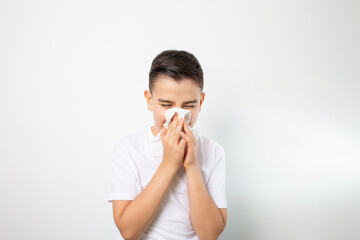 boy blowing his nose in a napkin