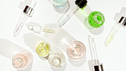 Cosmetic pipette with drops of oil close up into bottle. Extract, aromatic, essential oil. Cosmetics oils based on natural ingredients. Natural cosmetics production for hair and skin care. 4k 