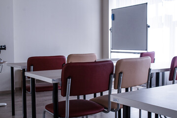 Small office with red chairs and a wooden table. Design