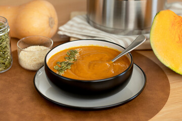 A plate with pumpkin soup puree, pumpkin and sesame seeds. Autumn menu. 