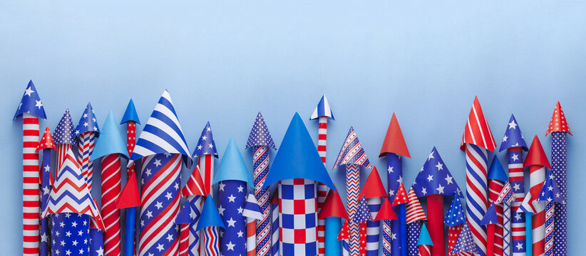 Banner of 4th of July bottle rockets or fireworks in USA colors of red, white, and blue for patriotic US American 4th of July celebration.