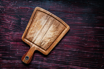 Old cutting board on dark  table. View from above. copy space.