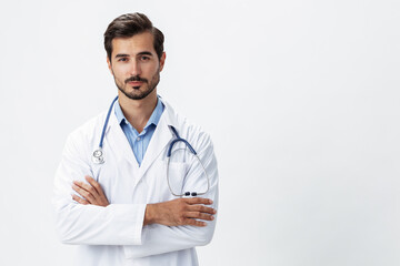 A man doctor in a white coat with a stethoscope and wearing serious glasses on a white insulated background looking into the camera, copy space, space for text, health