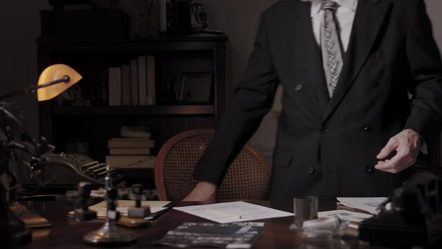 film noir detective walks in his office and starts working