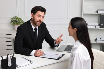 Human resources manager conducting job interview with applicant in office