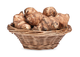 Wicker basket with many Jerusalem artichokes isolated on white
