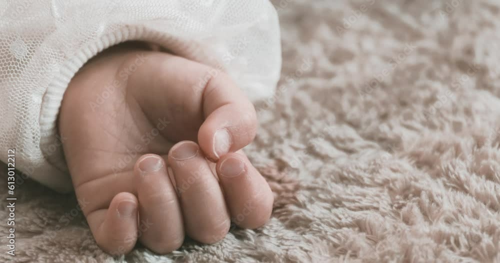 Wall mural a 2x slow motion of sleeping asian baby left hand on the carpet handheld